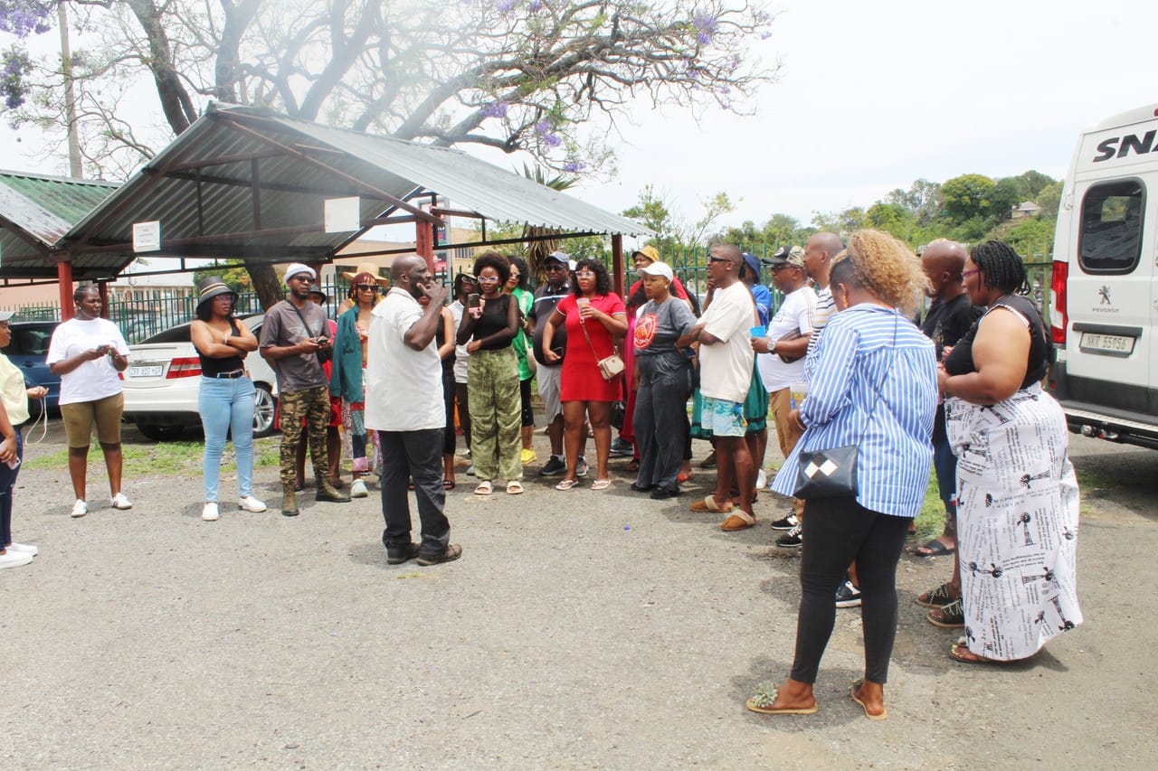 Tour guide briefing a large group of guests